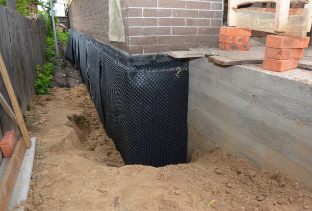Happy homeowners after waterproofing job in Carey